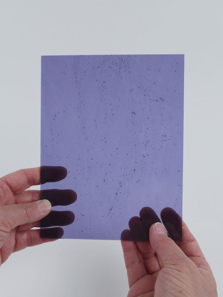 Video of the Pale Light Purple glass plate in transparent purple, 15x19cm, held up and tilted to show its pattern and transparency