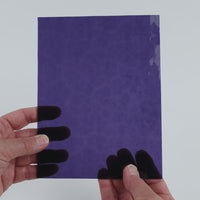 Video of the Purple Textured glass plate in hammered transparent purple, 15x19cm, held up and tilted to show its pattern and transparency