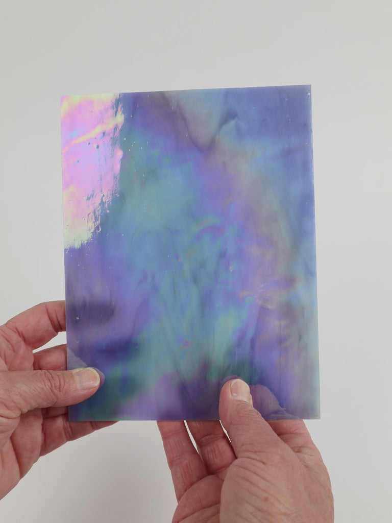 Video of the Hydrangea glass plate in iridescent translucent blue, 15x19cm, held up and tilted to show its pattern and transparency