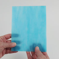 Video of the Azurite glass plate in translucent blue, 15x19cm, held up and tilted to show its pattern and transparency