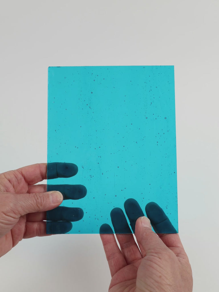 Video of the Clear Water glass plate in transparent blue, 15x19cm, held up and tilted to show its pattern and transparency
