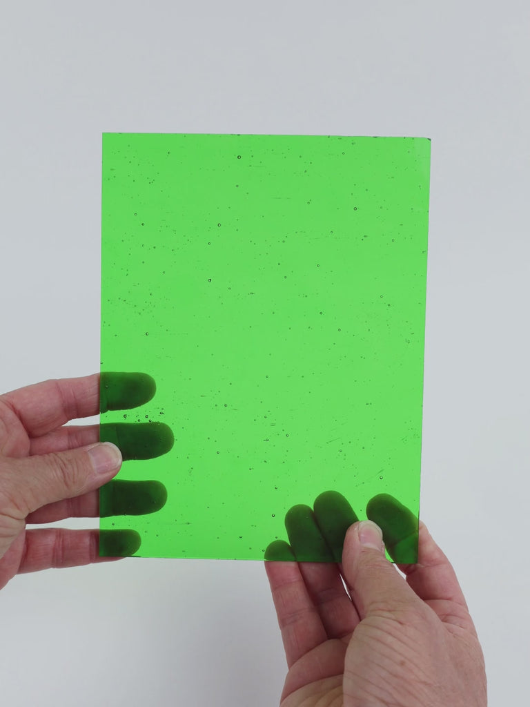 Video of the Neon Lime glass plate in transparent green, 15x19cm, held up and tilted to show its pattern and transparency