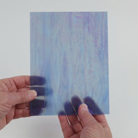 Video of the Marbled Blue Pearl glass plate in iridescent transparent blue, 15x19cm, held up and tilted to show its pattern and transparency