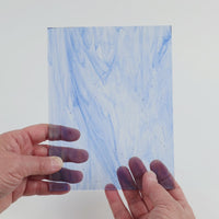 Video of the Light Blue Wispy glass plate in transparent blue, 15x19cm, held up and tilted to show its pattern and transparency