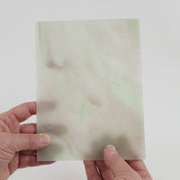 Video of the Light green Lilac Stipple glass plate in translucent green, 15x19cm, held up and tilted to show its pattern and transparency