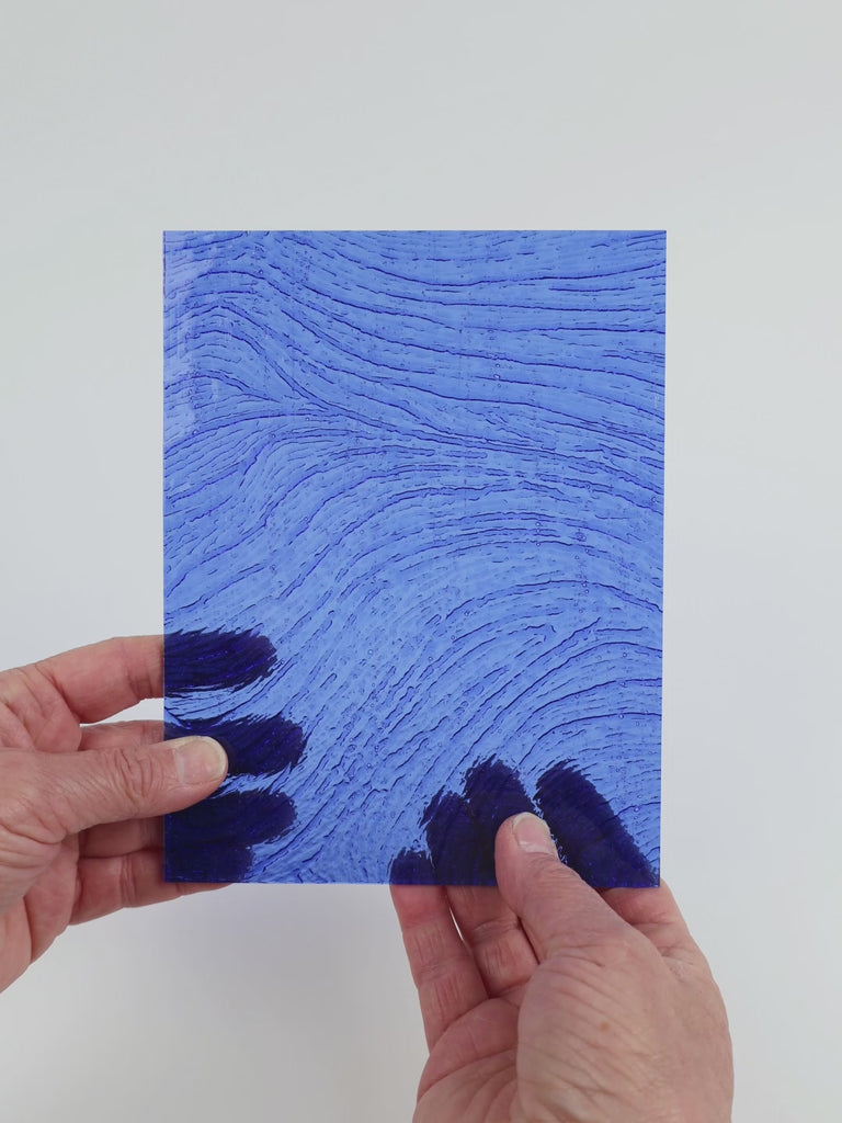 Video of the Cobalt Ripple glass plate in transparent blue, 15x19cm, held up and tilted to show its pattern and transparency