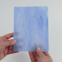 Video of the Soft Cloud glass plate in translucent blue , 15x19cm, held up and tilted to show its pattern and transparency
