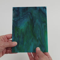 Video of the Waverider glass plate in translucent teal, 15x19cm, held up and tilted to show its pattern and transparency