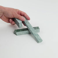 Video of Marble Bars XL Verde Jade in opaque green natural marble, 1–20 cm long and 8 mm thick, picked up by hand and turned to show their length, colour and natural veining