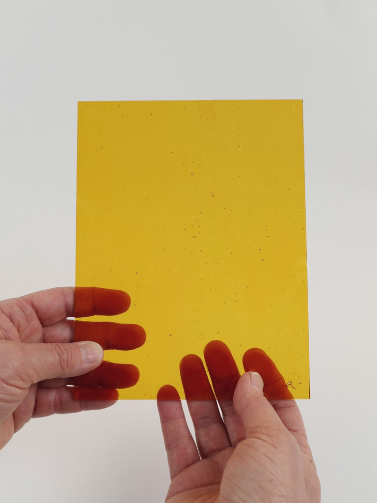 Video of the Golden Brown glass plate in transparant brown, 15x19cm, held up and tilted to show its pattern and transparency