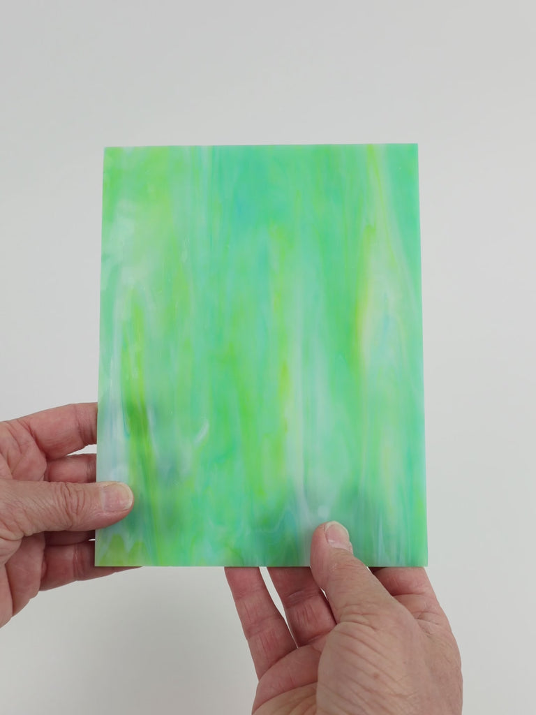 Video of the Sea Green Mottle glass plate in translucent teal, 15x19cm, held up and tilted to show its pattern and transparency