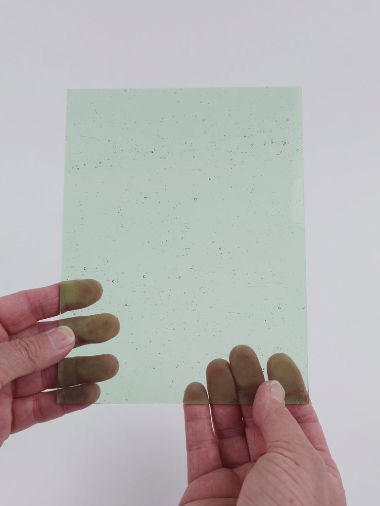 Video of the Tinted Green glass plate in transparent green, 15x19cm, held up and tilted to show its pattern and transparency