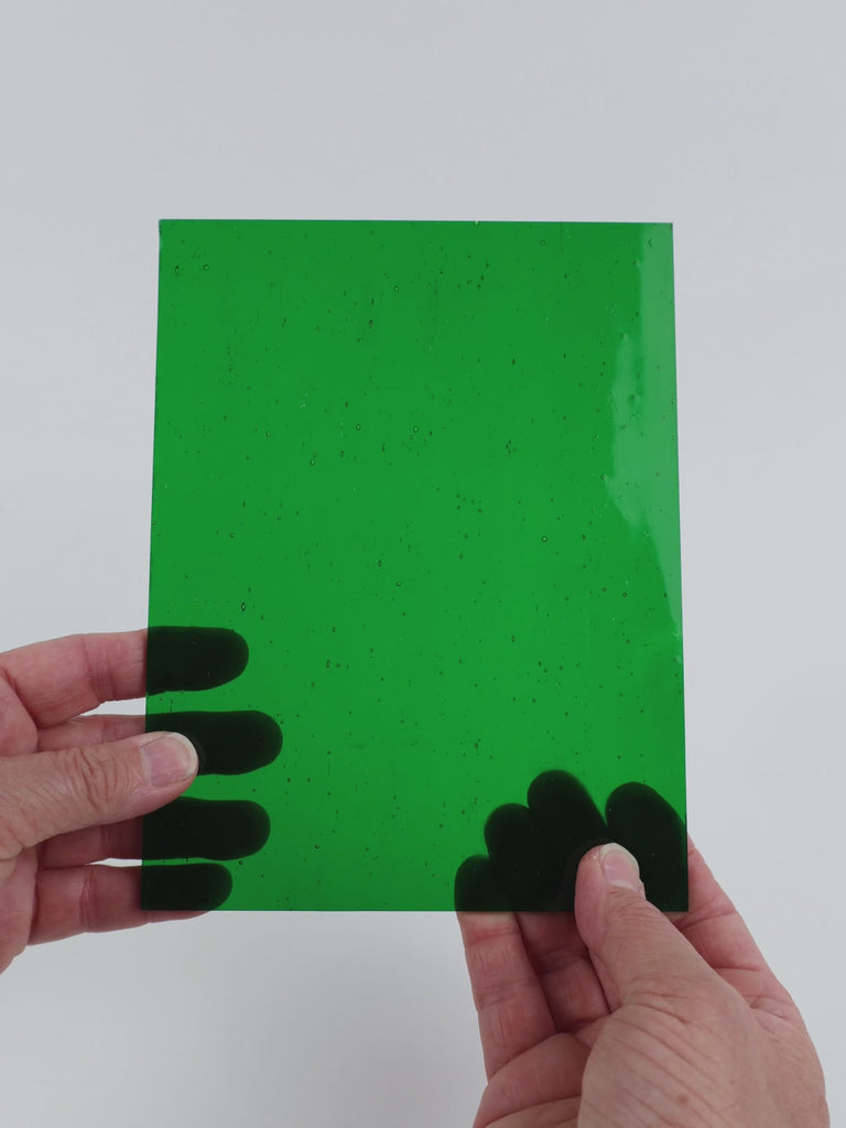Video of the Emerald Green glass plate in transparent green, 15x19cm, held up and tilted to show its pattern and transparency
