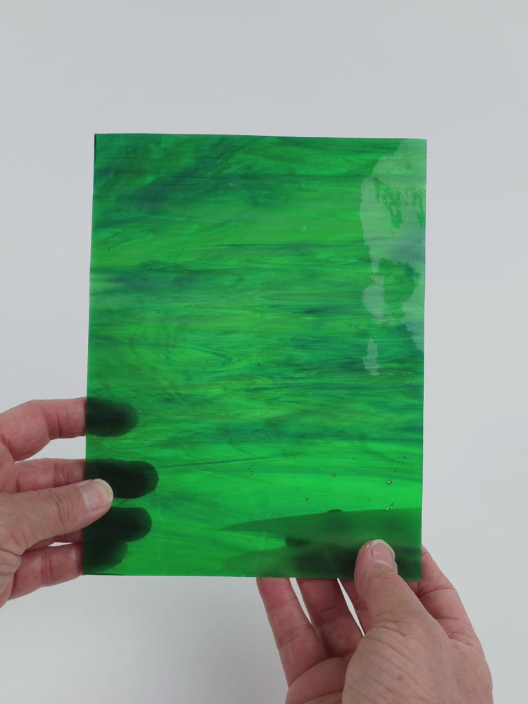 Video of the Mystic glass plate in translucent green-teal-blue, 15x19cm, held up and tilted to show its pattern and transparency
